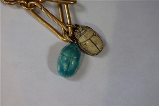 An 18ct bracelet, hung with five assorted charms, gross 33 grams.
